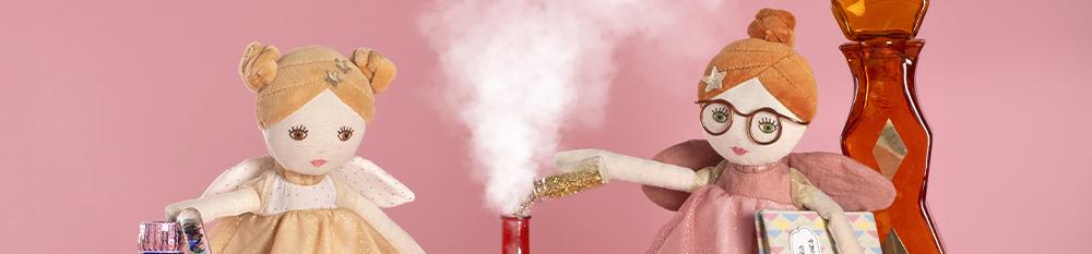 two fairy dolls making magic spells on a pink background magical gifts for children