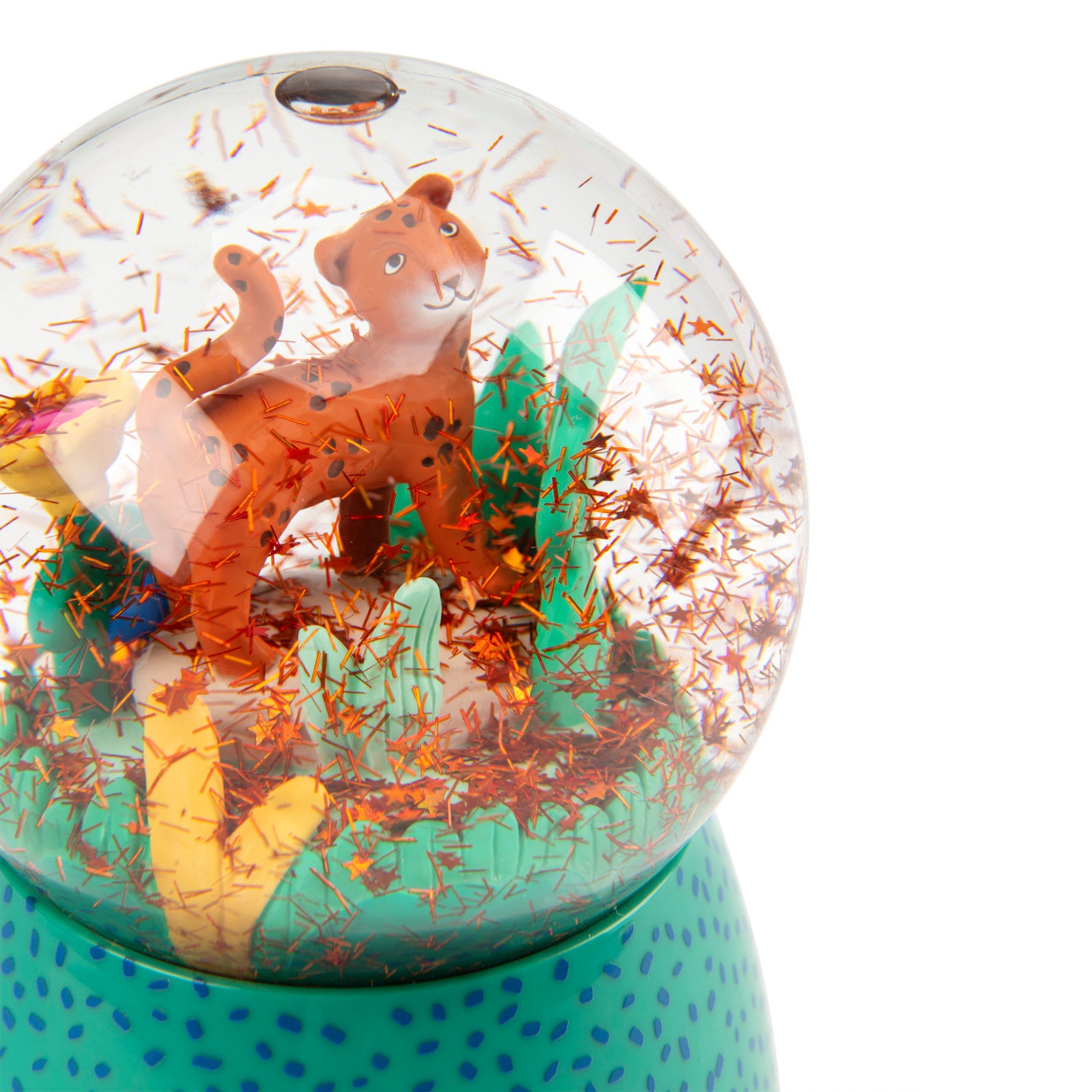 Glass snow globe with a lion figure and colorful interior on a white background