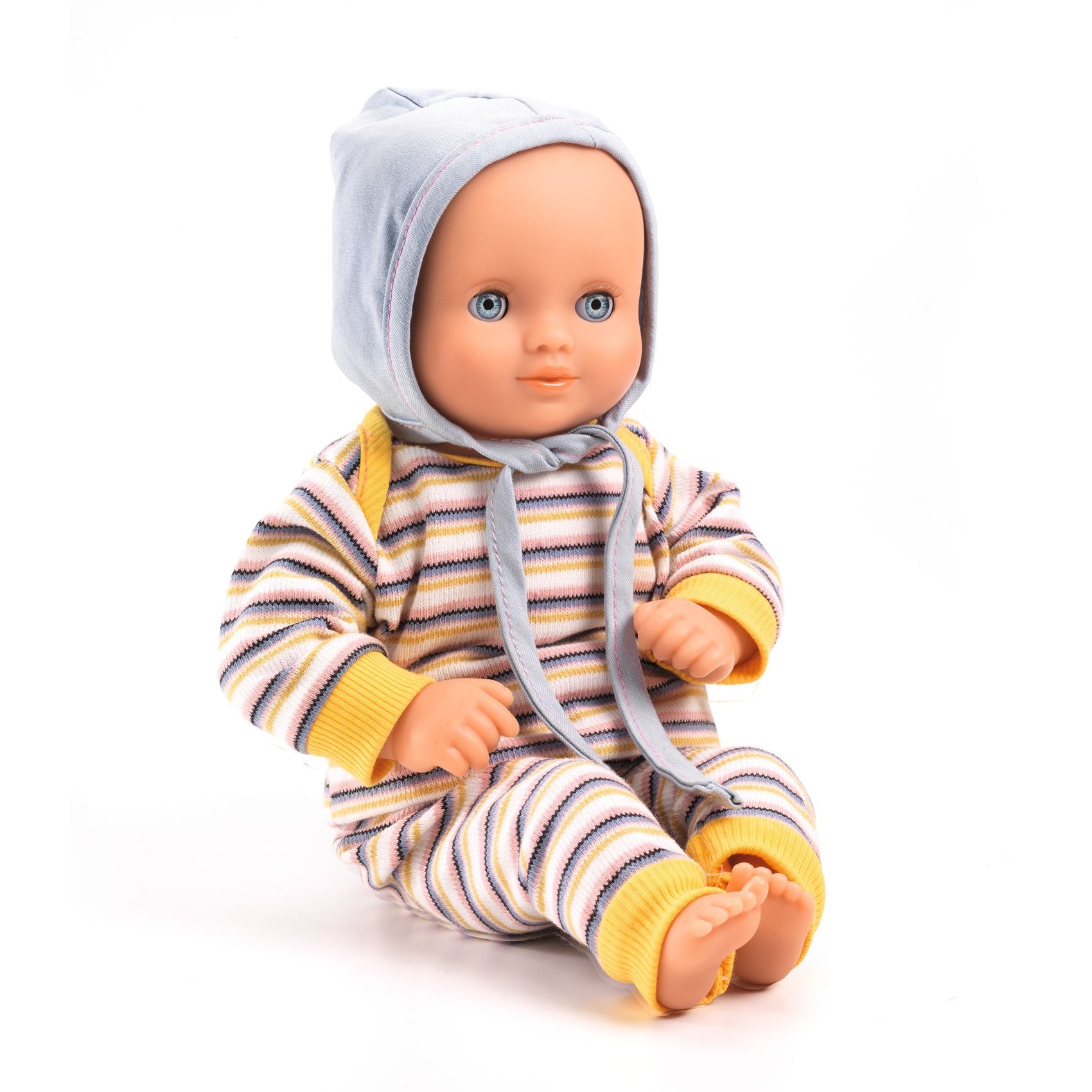 Baby doll wearing a striped onesie and bonnet on a white background