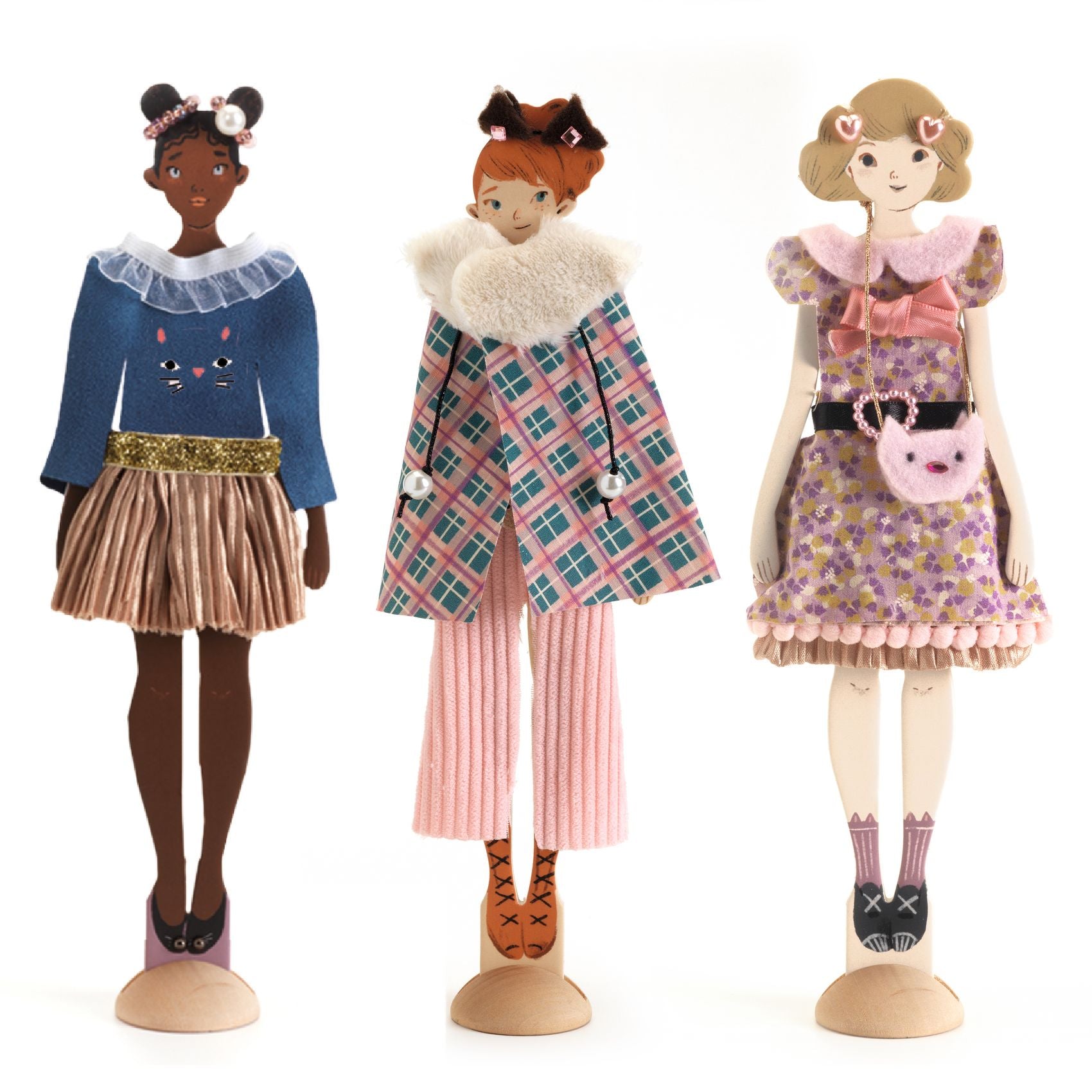 Three dolls with different outfits on a white background
