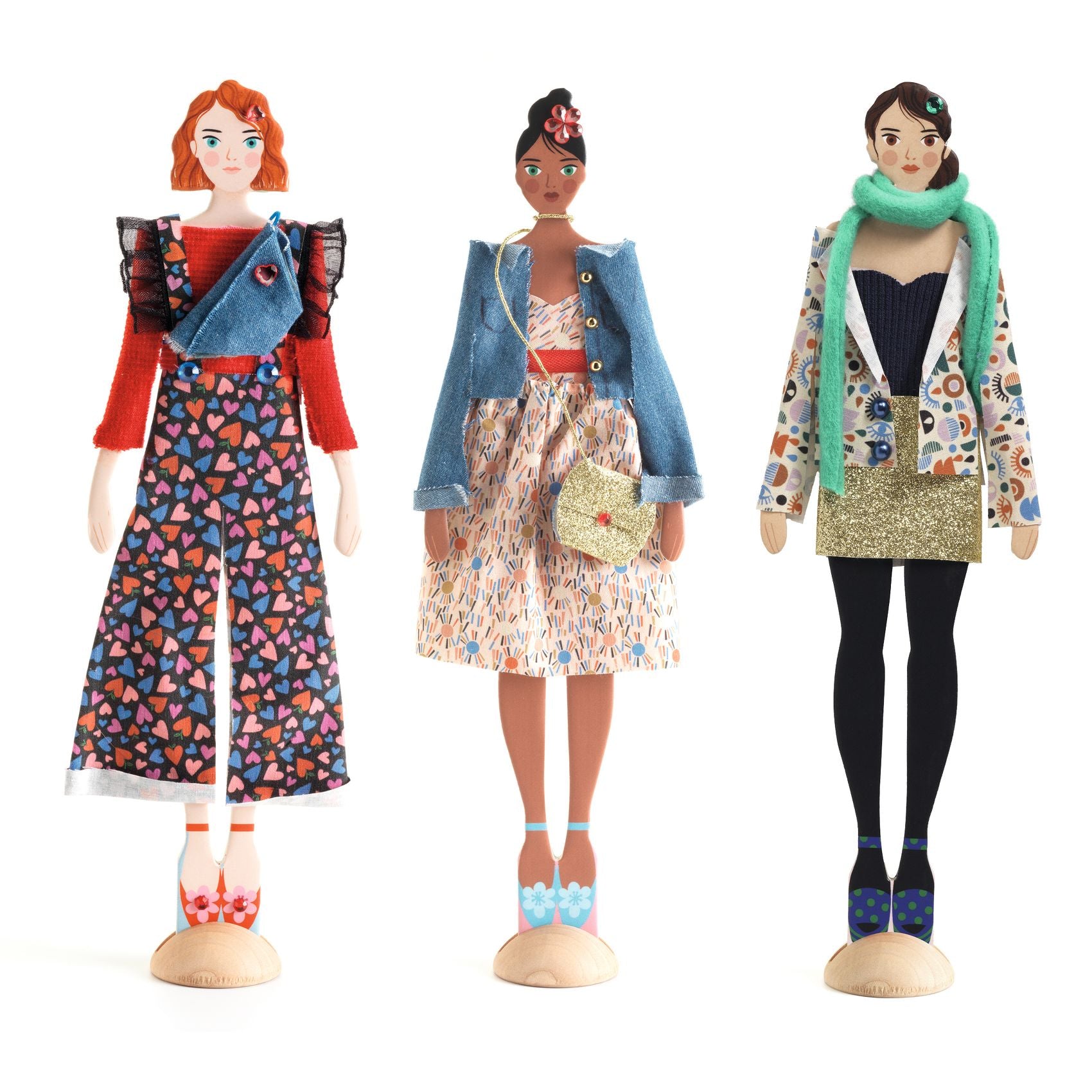 Three dolls with different outfits on a white background