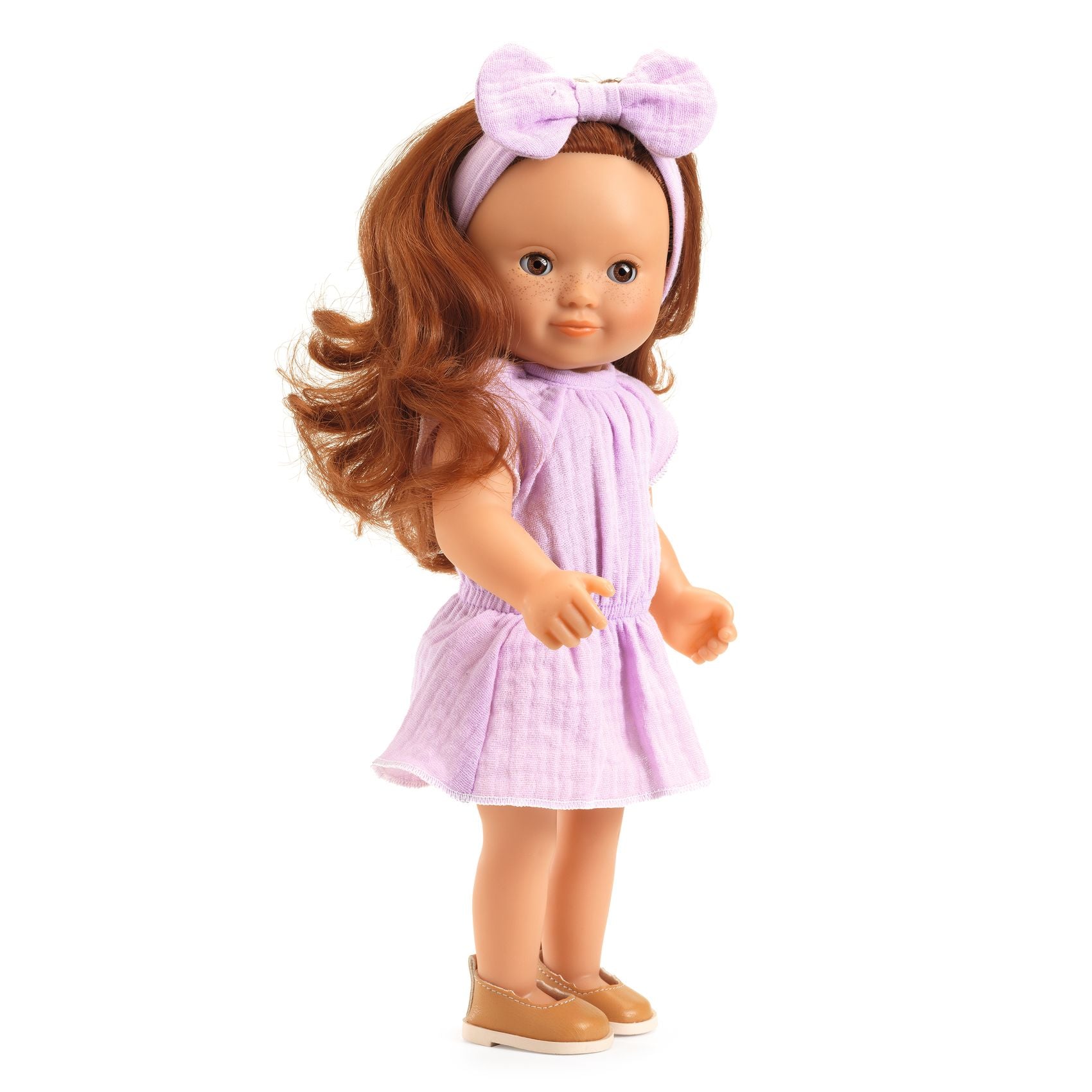 Doll with brown hair and a purple dress on a white background
