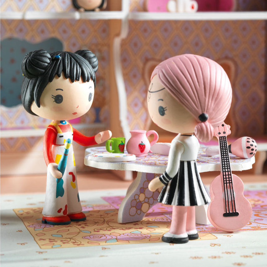 Two toy figures in a room with shelves and decorative items.
