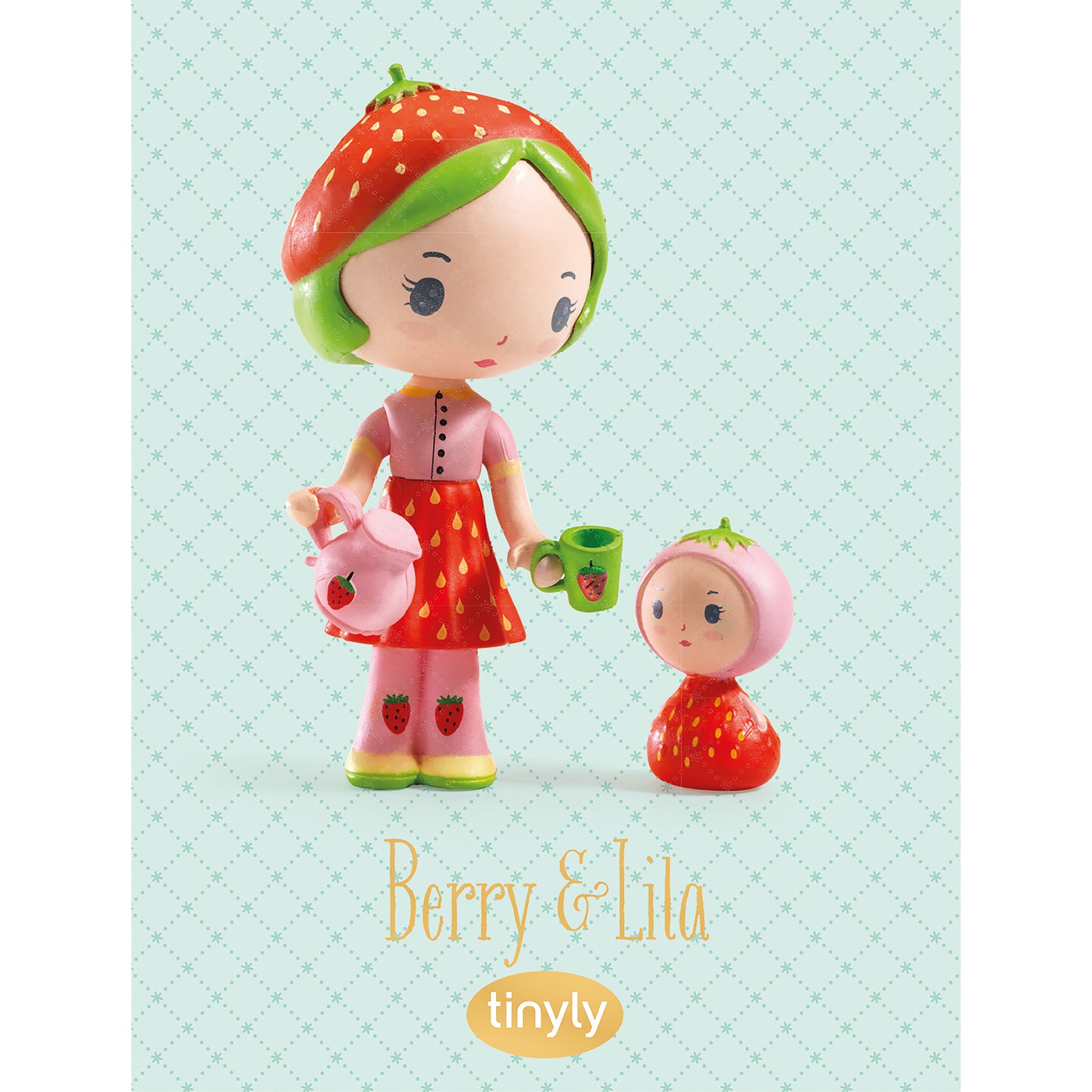 Two strawberry-themed figurines with a light blue background, featuring the brand 'tinyly'.