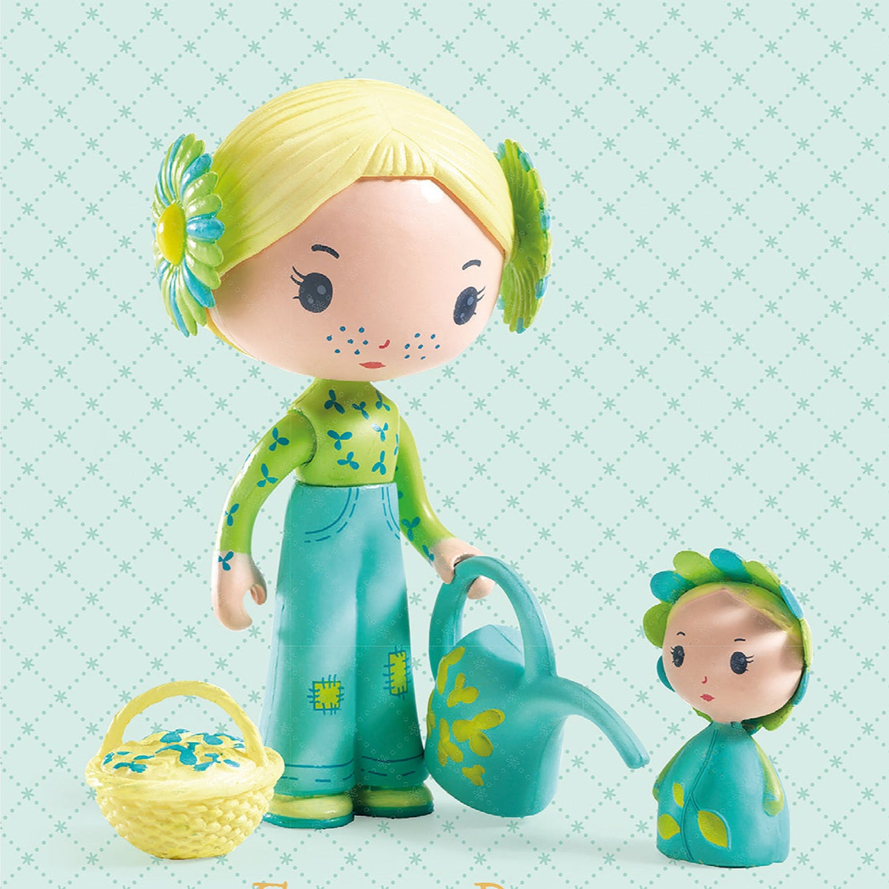 Two dolls, one holding a watering can and basket, on a light blue background with 'Flore & Bloom' and 'tinyly' text.