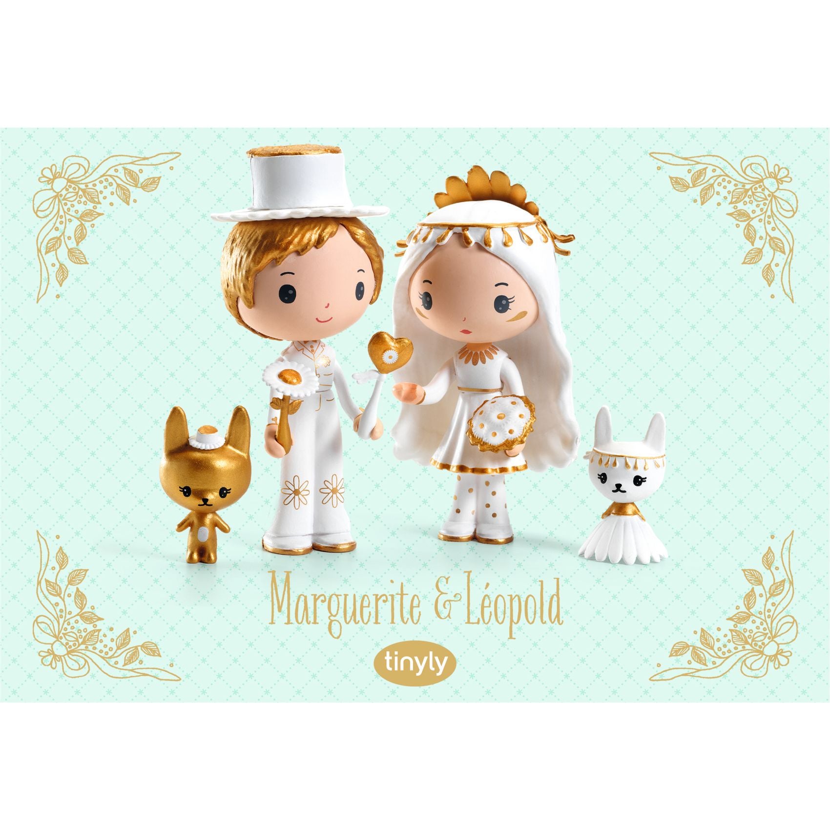 Two small figurines of a boy and girl in wedding attire with decorative elements on a light green background.