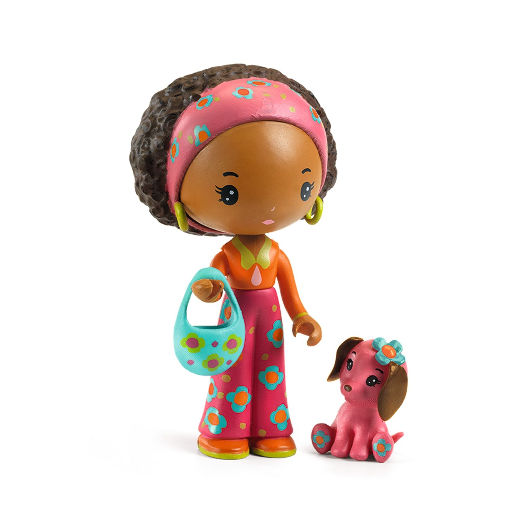 Toy figure of a girl with a dog on a white background