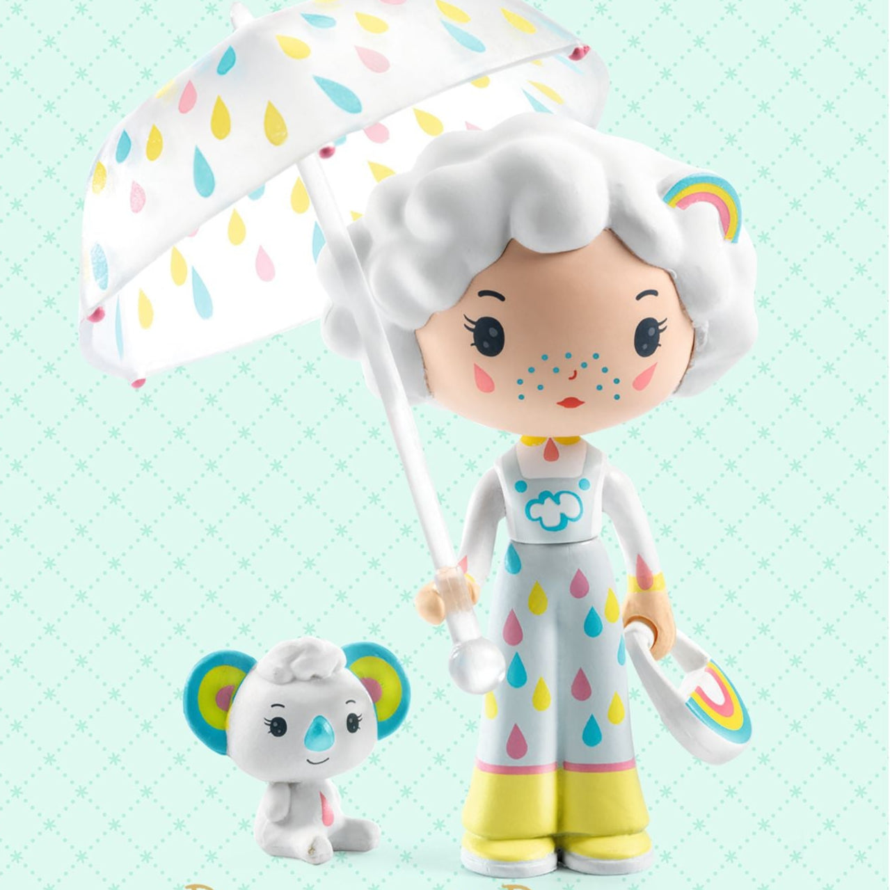 Two toy figures, one with a colorful umbrella and the other a small animal, on a light blue background with 'tinyly' branding.