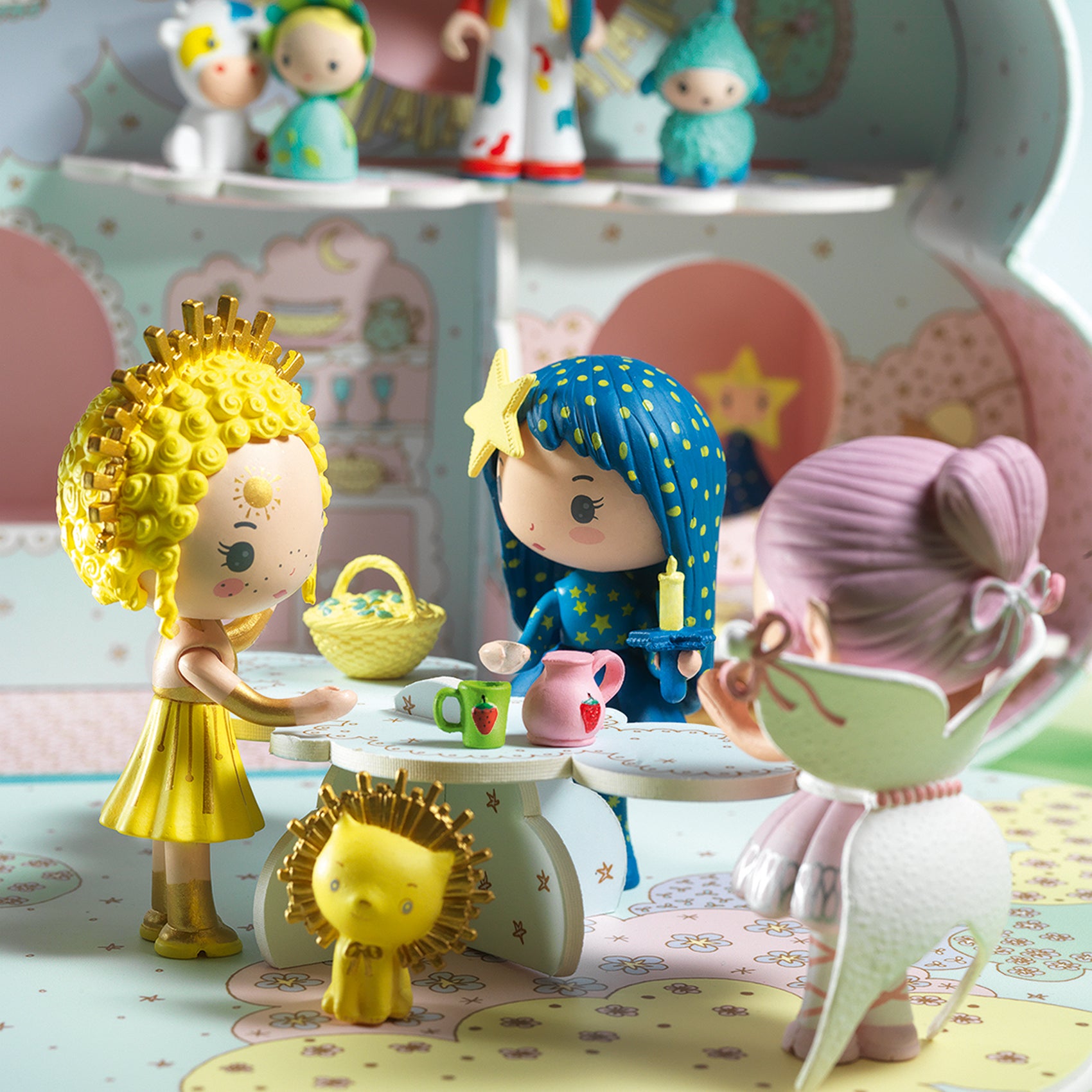 Toy figurines in a play setting with a colorful background