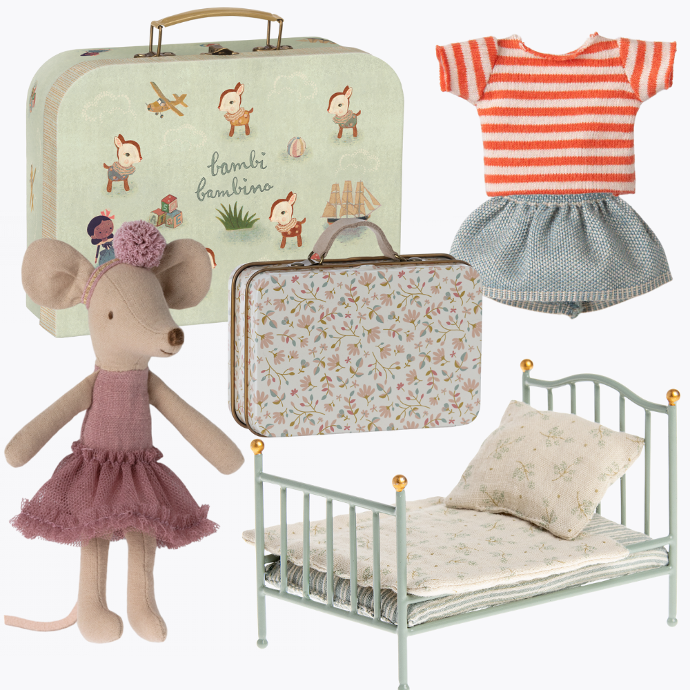 Collection of children's items including a suitcase, maileg mouse doll, bed, and clothing on a white background