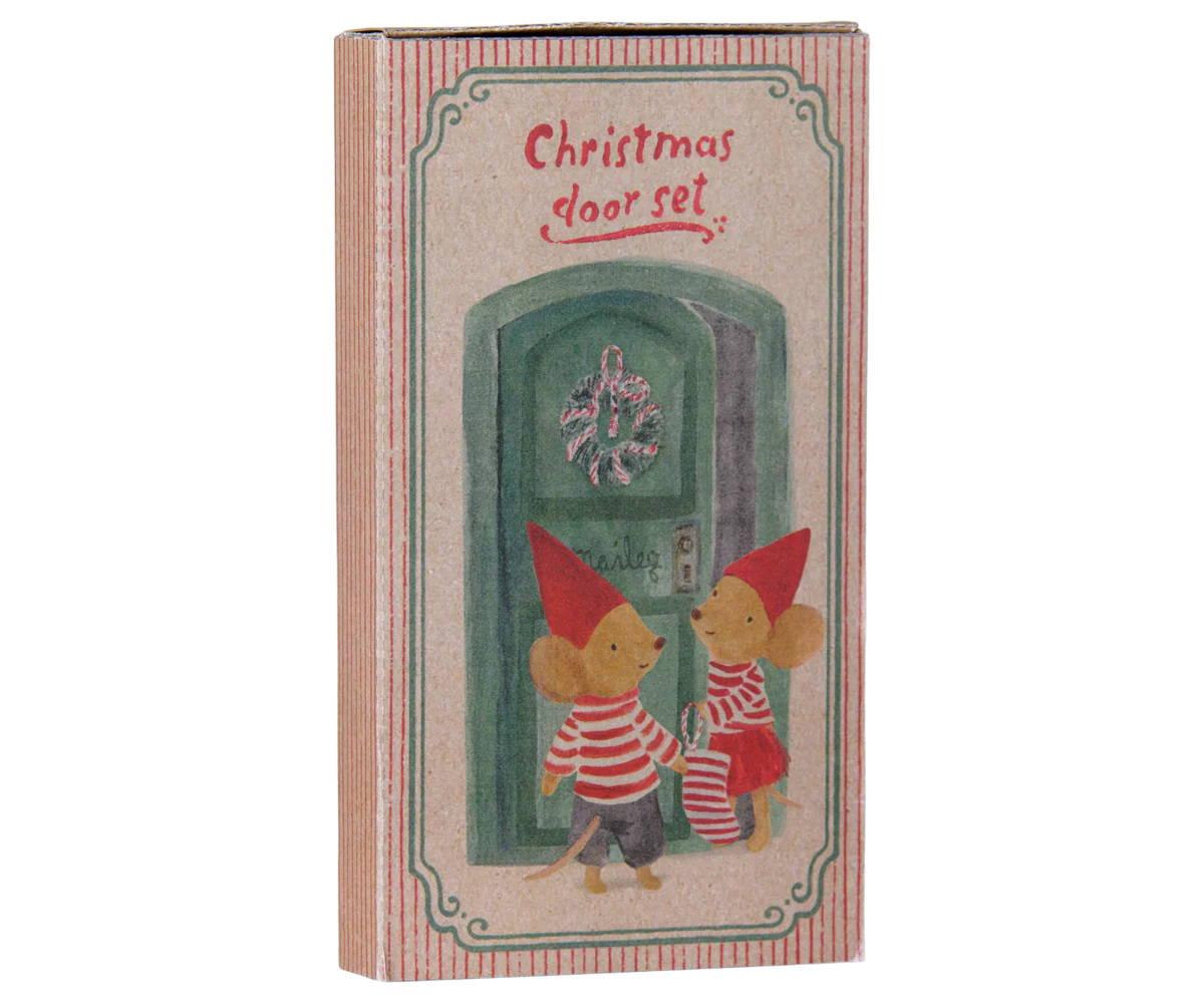 A vintage-style illustrated box labeled 'Christmas door set' with two small mouse figures standing in front of a green door, shown on a plain white background.