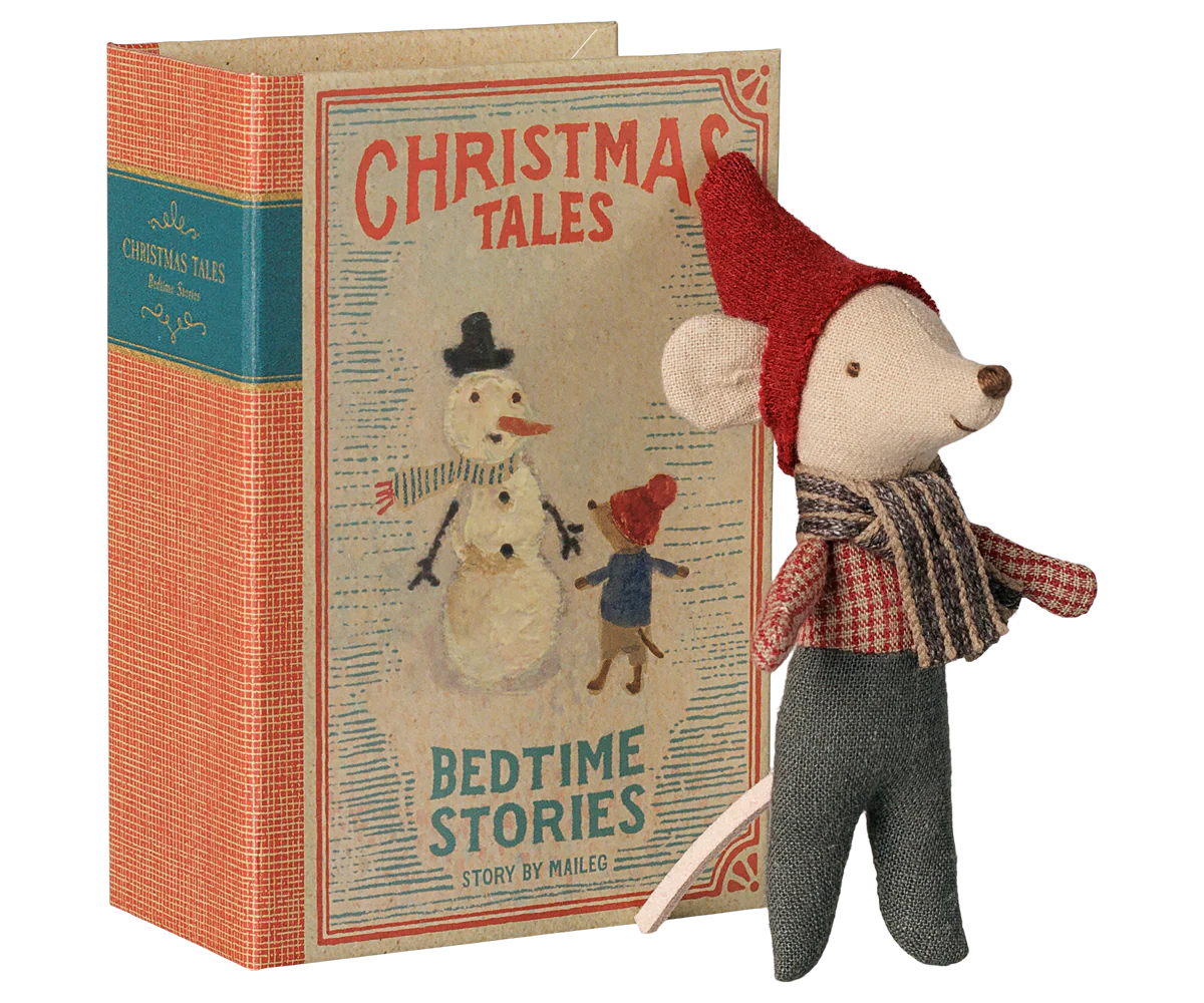 A vintage-style children's book titled 'Christmas Tales: Bedtime Stories' with an illustrated snowman and child on the cover, shown next to a small plush mouse doll wearing a red hat, plaid scarf, and gray pants on a white background.