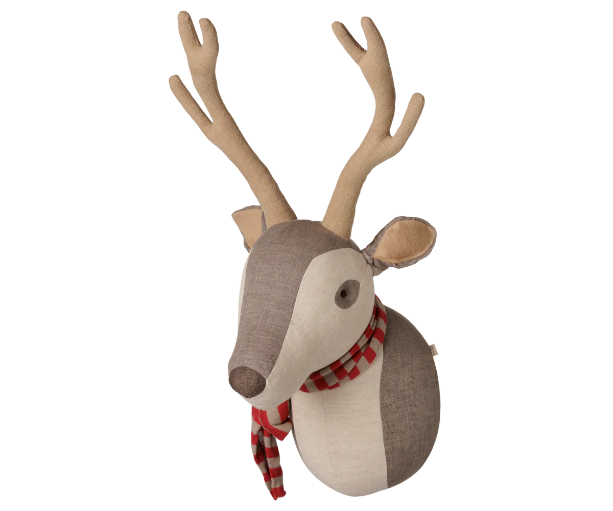A decorative fabric reindeer head wall hanging with tan antlers, a brown and cream face, and a red-and-white checkered scarf, shown on a plain white background.