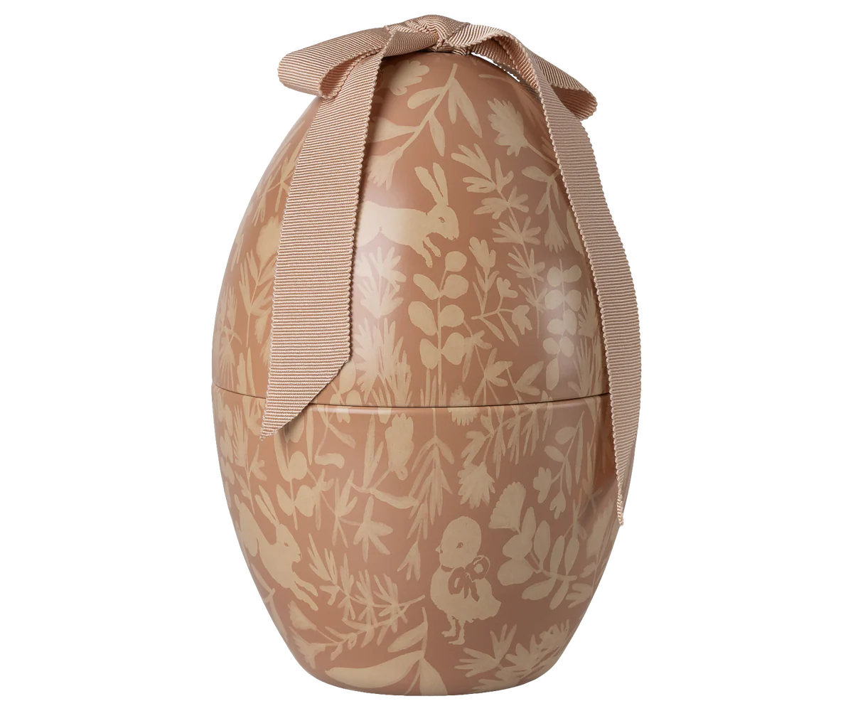 Decorative egg-shaped container with a floral pattern and ribbon on a white background