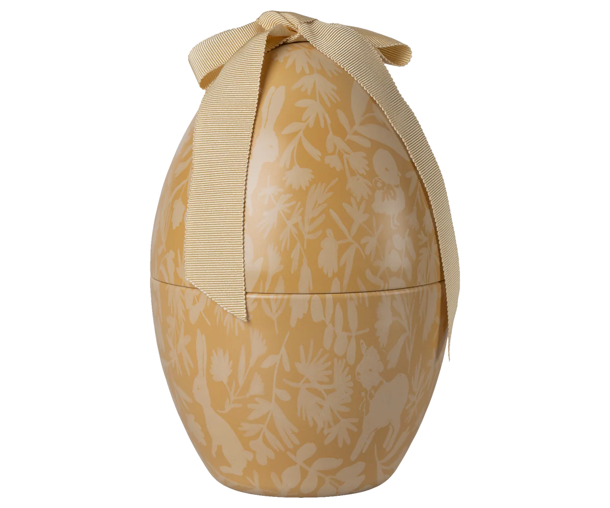 Decorative egg-shaped box with floral pattern and ribbon on a white background