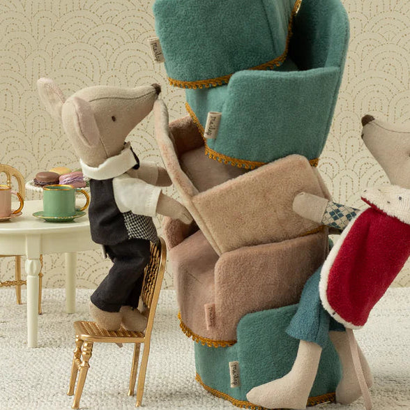 maileg king mouse with Stack of plush chairs with animal figures on a neutral background
