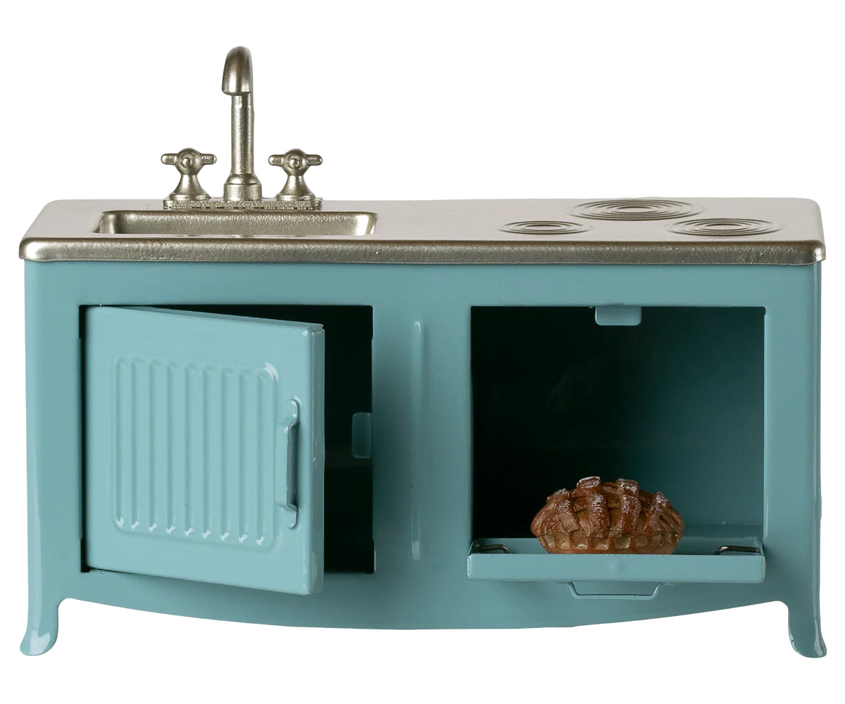 Teal dollhouse kitchen set with sink and stove on a white background