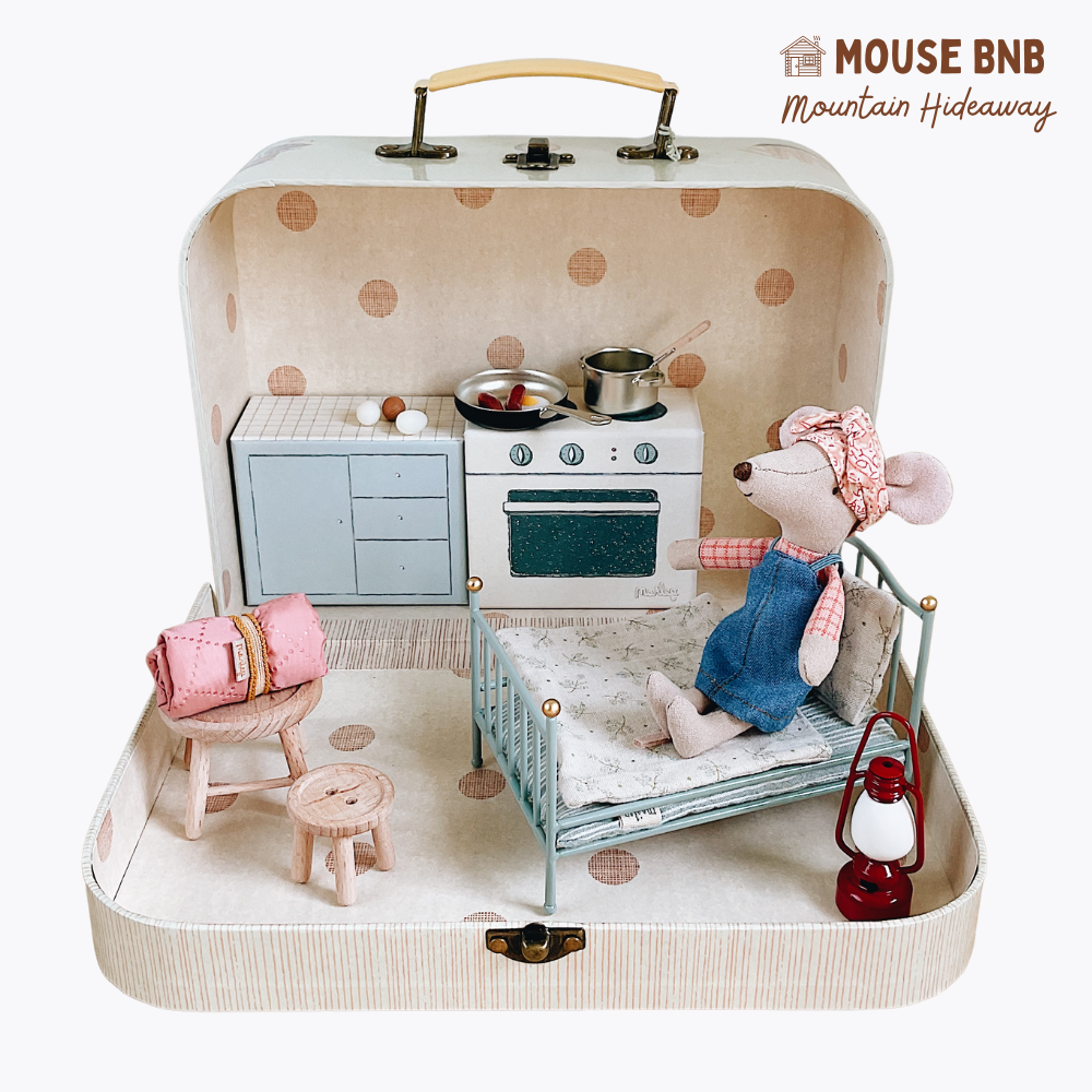 Miniature mouse-themed room set inside a suitcase with 'Mouse BNB' branding.