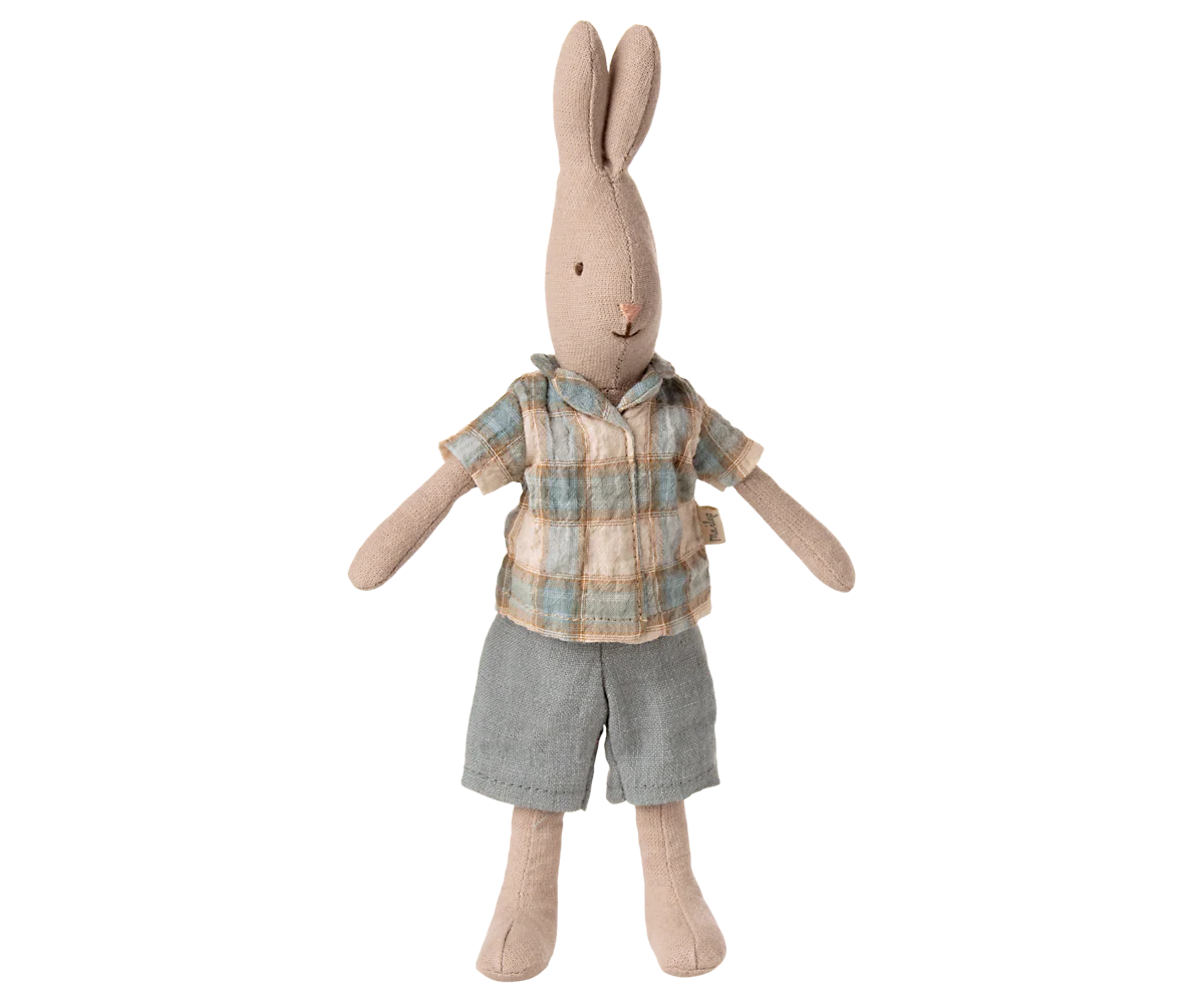 Stuffed rabbit toy wearing a plaid shirt and shorts on a white background
