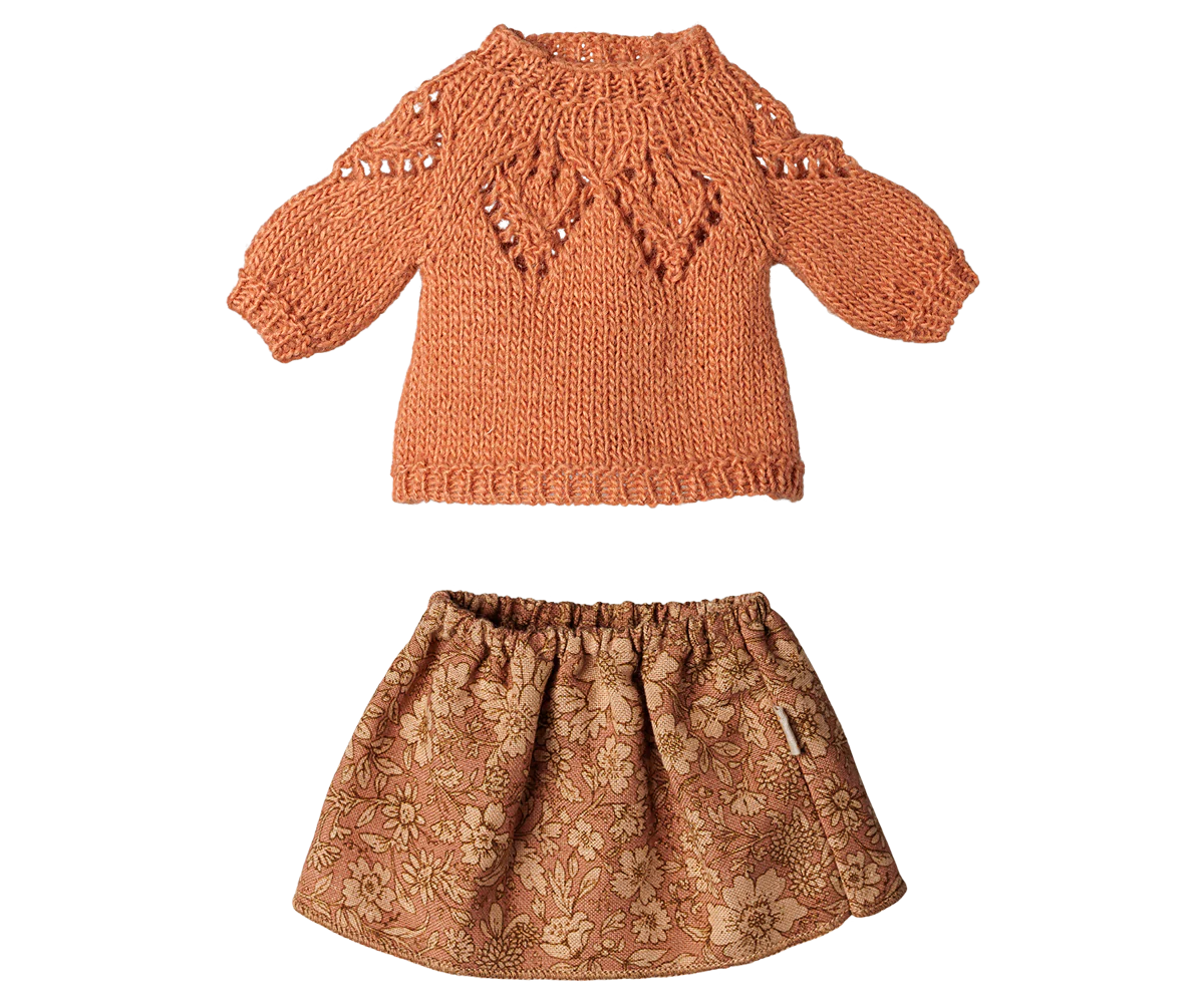 A two-piece children's outfit set featuring a rust-orange knit sweater with textured details and a matching brown floral-patterned skirt, displayed on a solid white background.