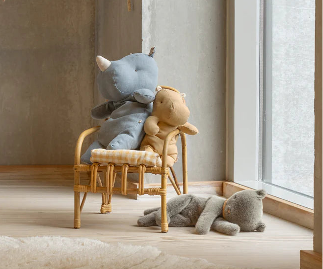 Children's room with plush toys and a decorative flag banner.