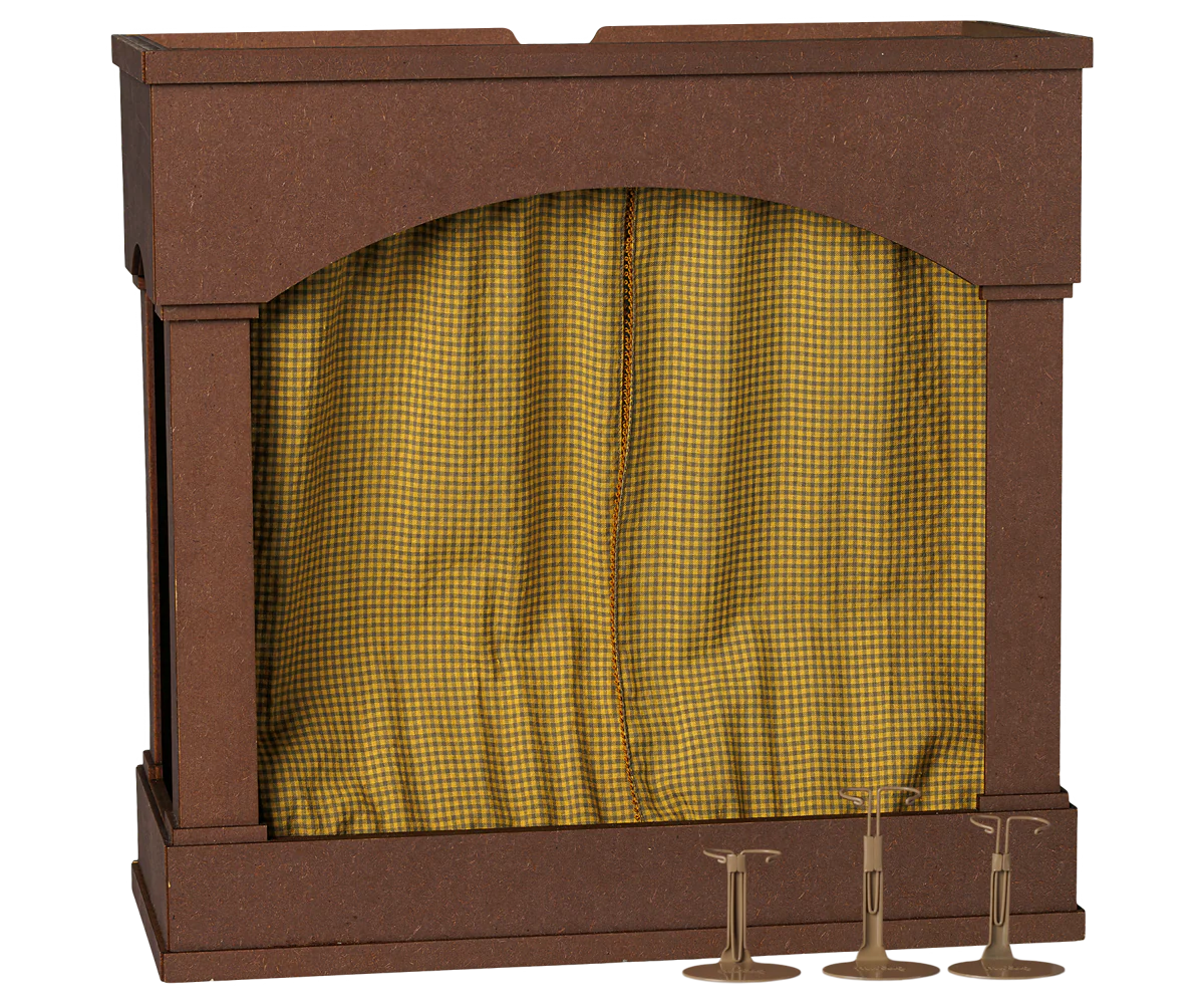 A miniature toy stage set with a brown wooden-looking frame and a yellow-and-black checkered curtain, shown on a plain white background with three small brass bell props at the base.