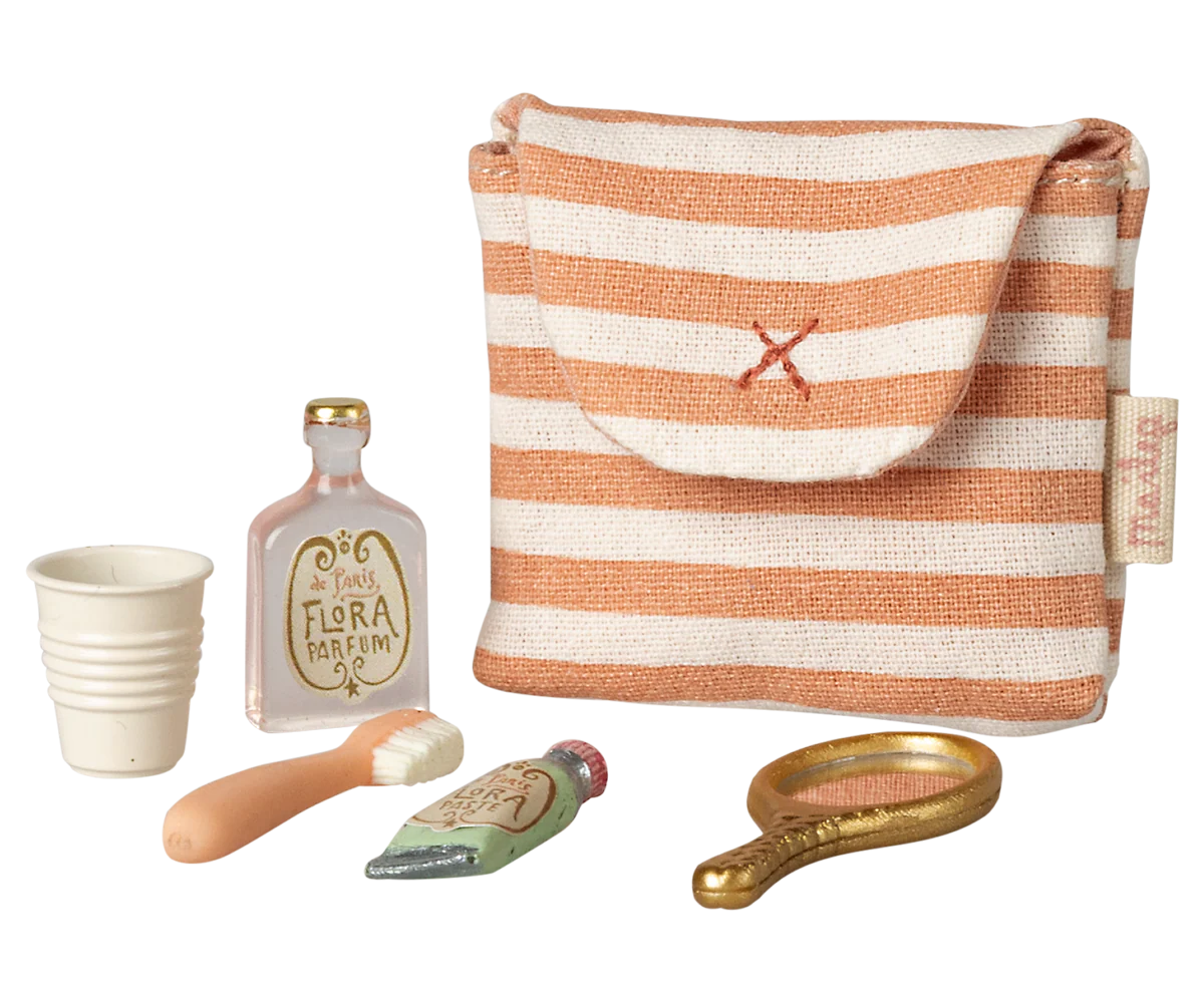 Set of miniature items including a striped bag, bottle, cup, and tools on a white background