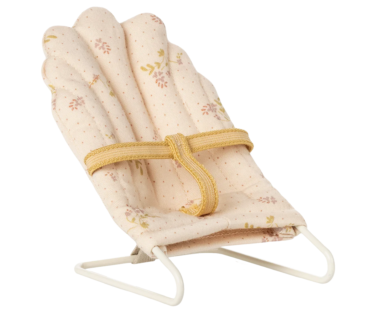 miniature dolls house baby bouncer with floral pattern and yellow strap on a white background