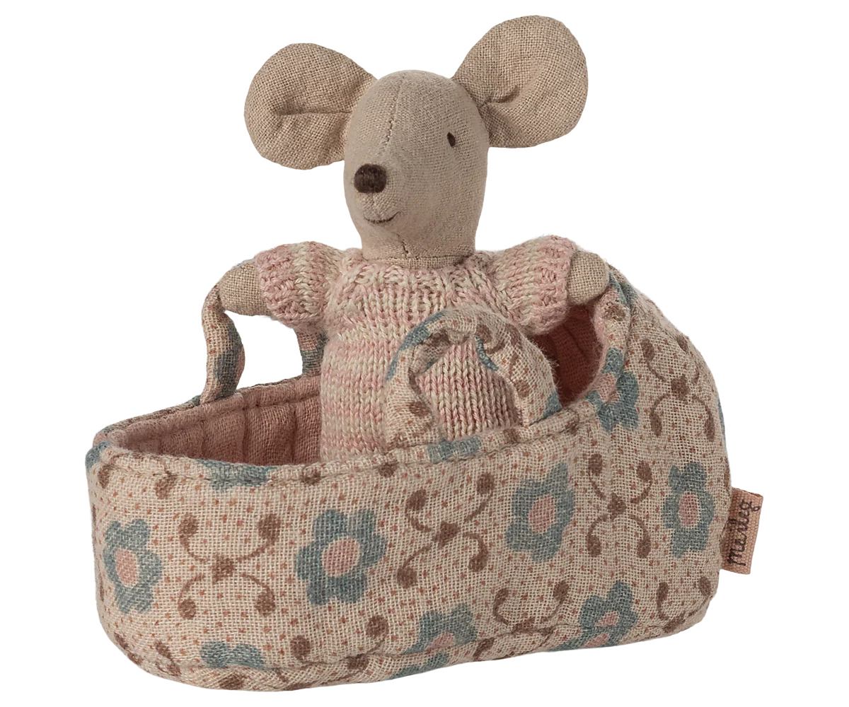 Stuffed mouse toy in a floral-patterned basket on a white background