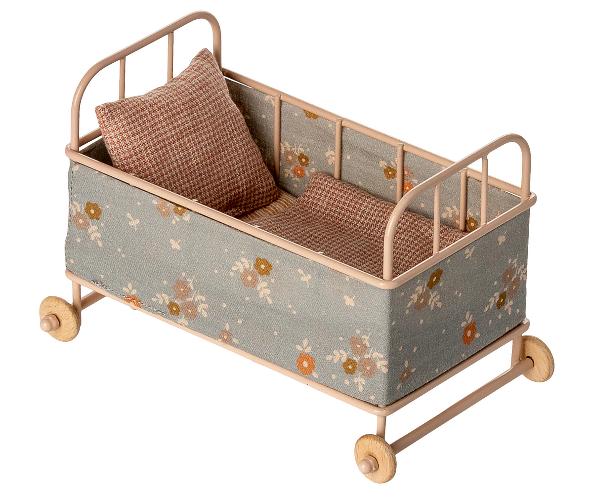 Maileg mouse cot bed with floral pattern and wooden wheels on a white background