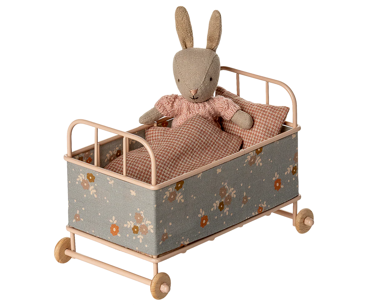 Maileg Toy rabbit in a small cot with floral pattern on a white background