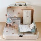 Maileg Miniature bedroom set inside a suitcase with a bed, chair, and wardrobe.