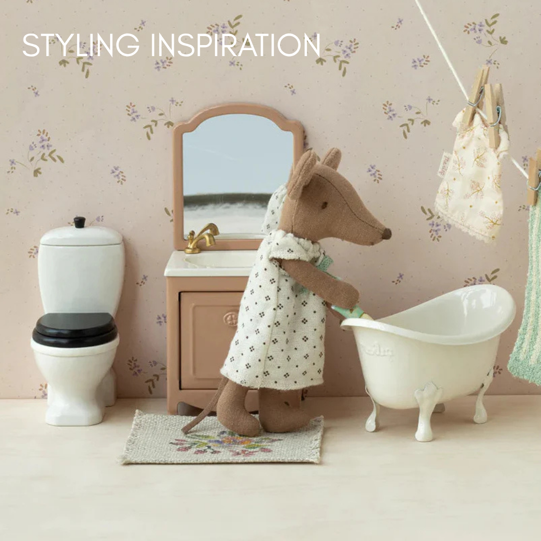 Small toy MAILEG MOUSE in a bathroom setting with a sink, toilet, and bathtub.