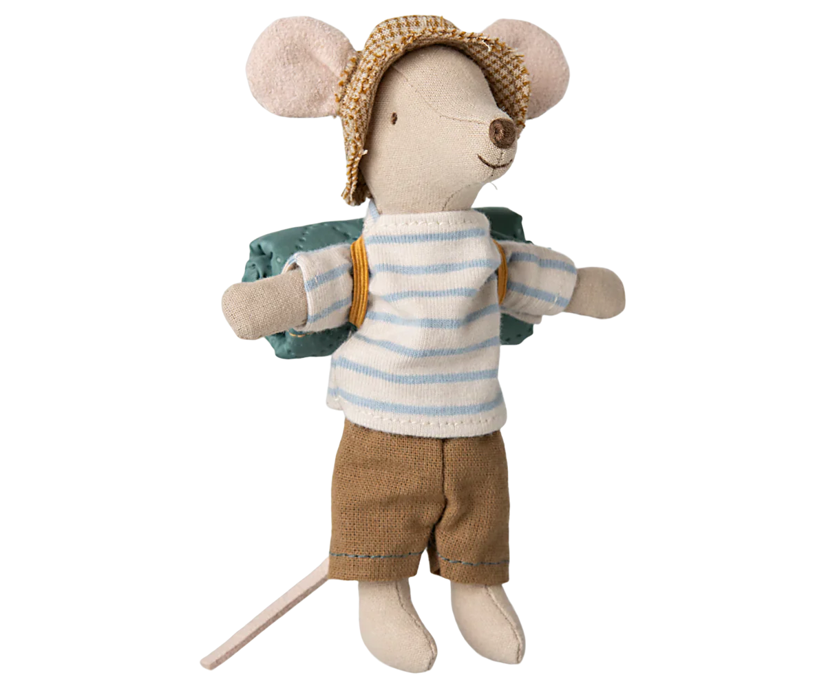Toy mouse dressed in a striped shirt, shorts, and hat with a backpack on a white background