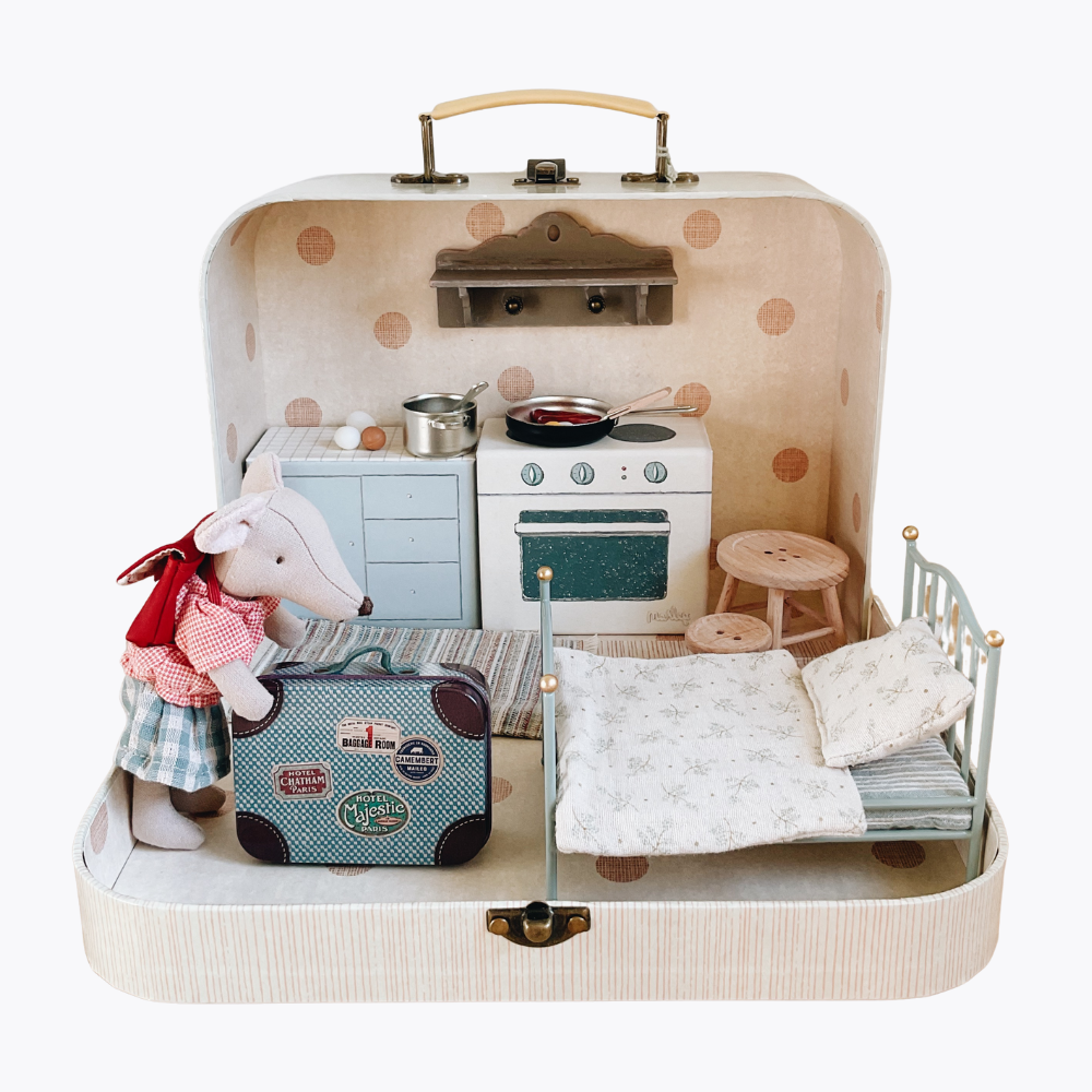 Maileg Toy kitchen set inside a suitcase with a bed and stuffed toy Maileg mouse on a white background