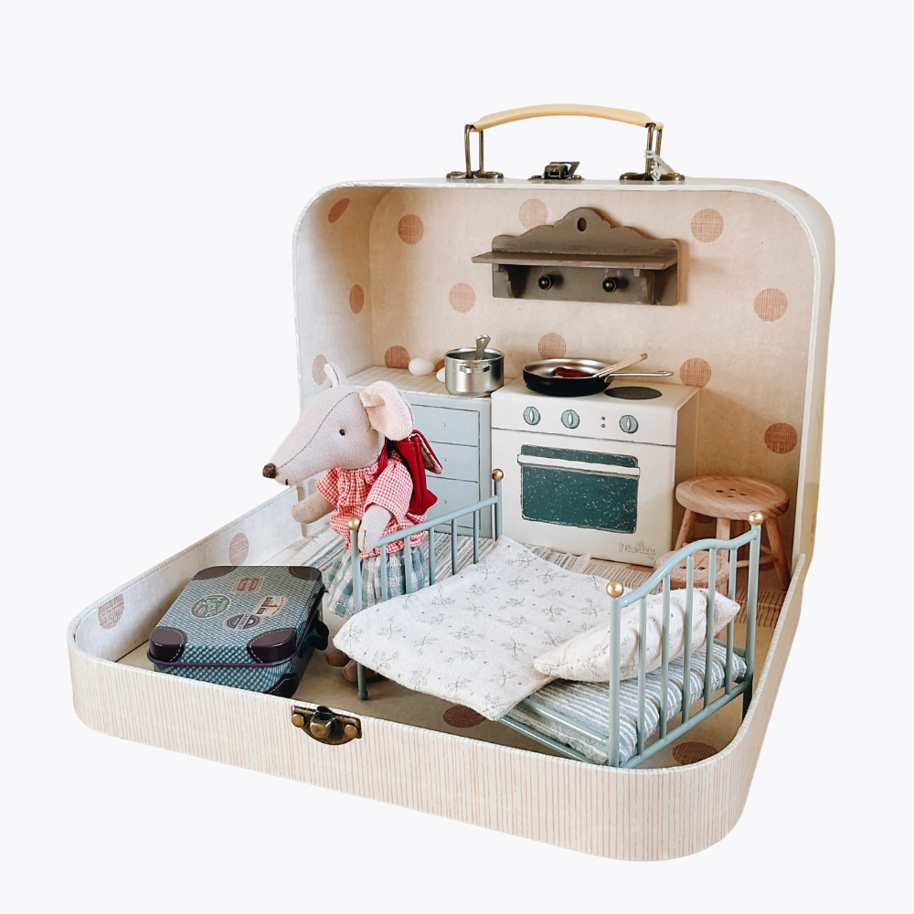 Maileg Toy kitchen set inside a suitcase with a bed and stuffed toy Maileg mouse on a white background