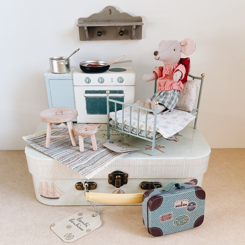 Maileg cooking set with a bed and mouse all on a bambi bambino maileg suitcase.