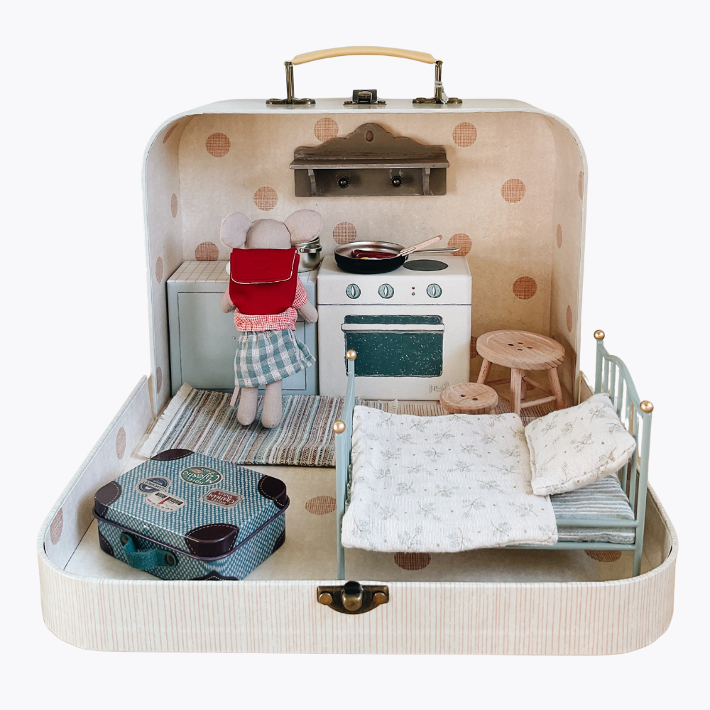 Maileg Toy kitchen set inside a suitcase with a bed and stuffed toy Maileg mouse on a white background