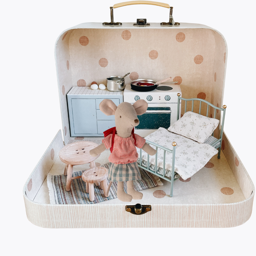 Miniature mouse family in a suitcase playset with kitchen and bedroom furniture.