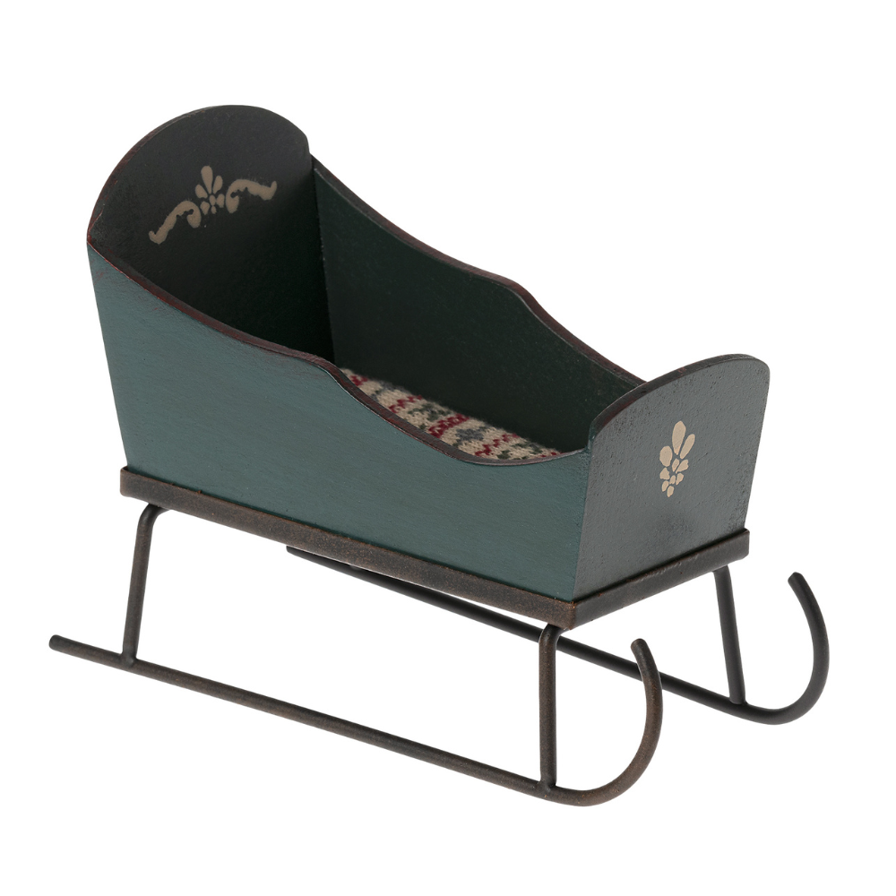 Vintage-style baby crib with floral patterned interior on a white background