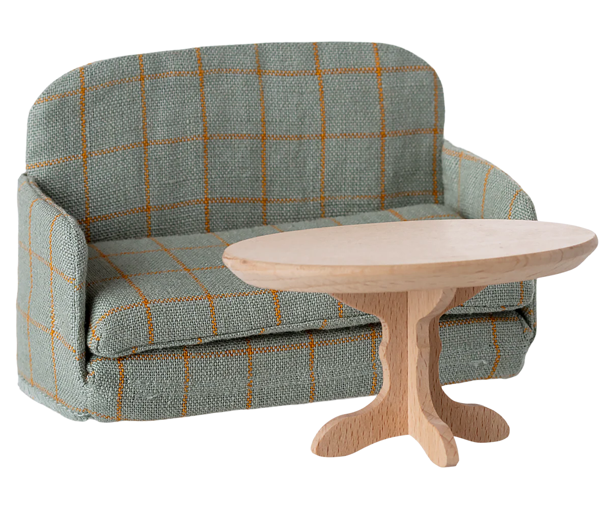 Maileg  sofa bed with a wooden coffee table on a white background