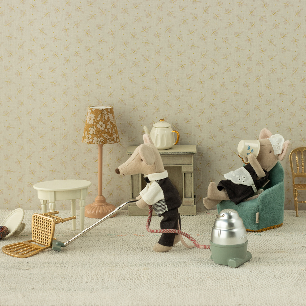 MAileg mice watier and maid in a living room with a vacuum cleaner