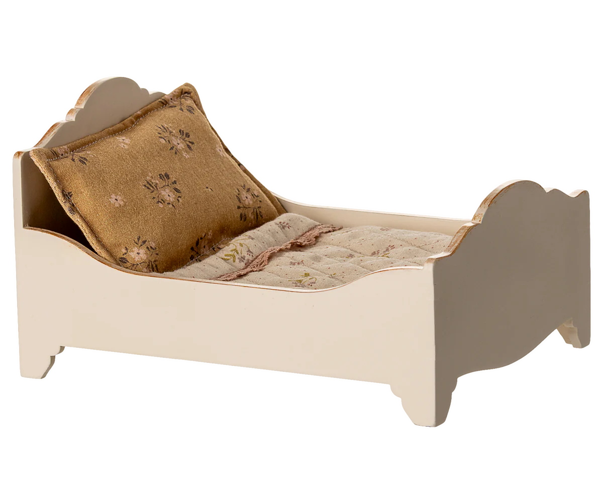 Maileg dolls house bed with a pillow and blanket on a white background