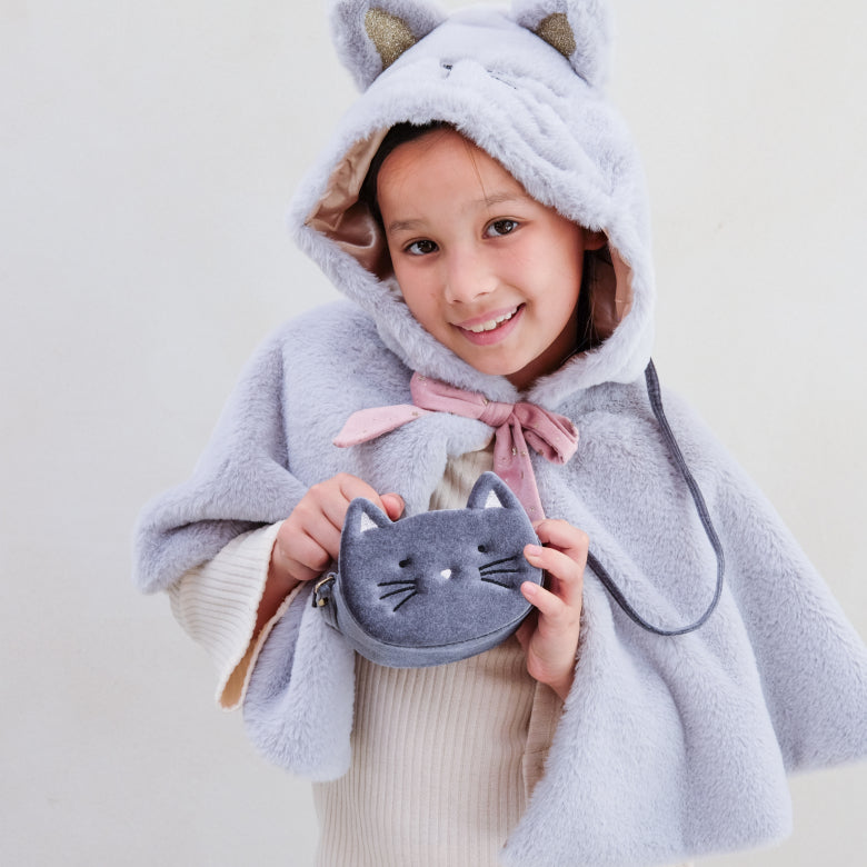 Child wearing a gray cat-themed hooded cloak holding a matching pouch.