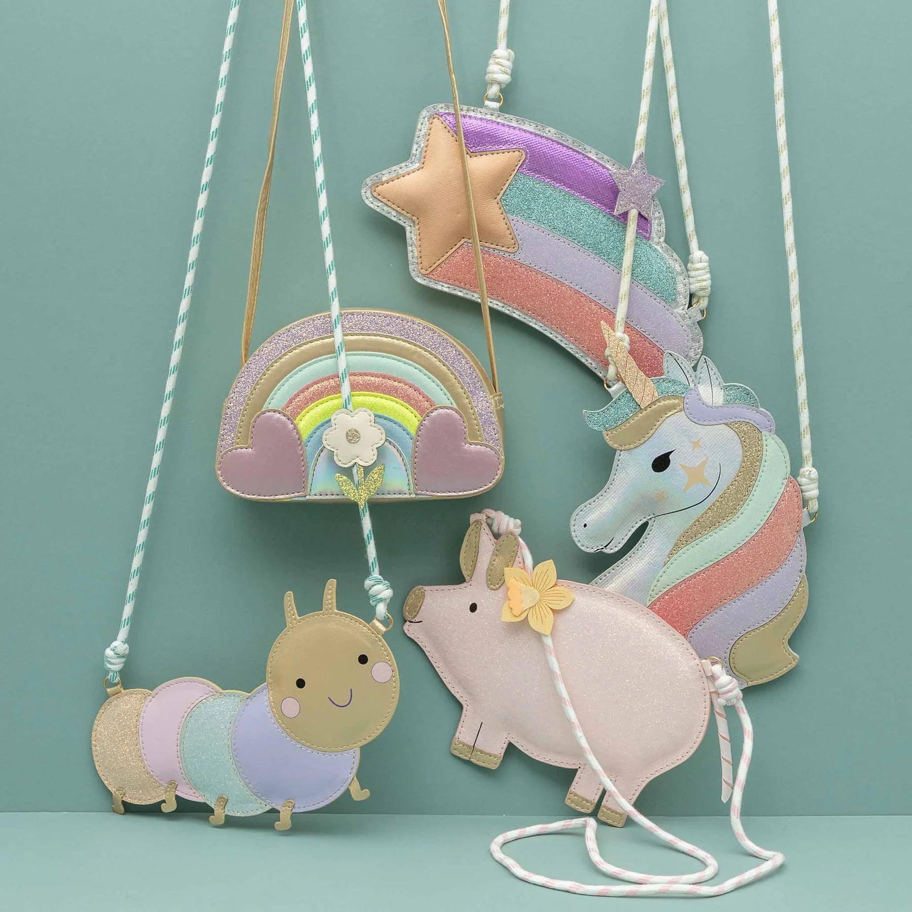 Children's bags with a unicorn, rainbow, and caterpillar on a teal background