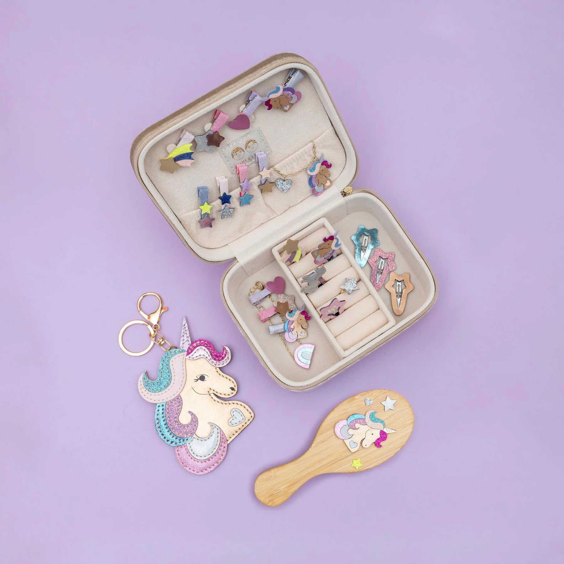 Open jewelry case with hair accessories on a purple background