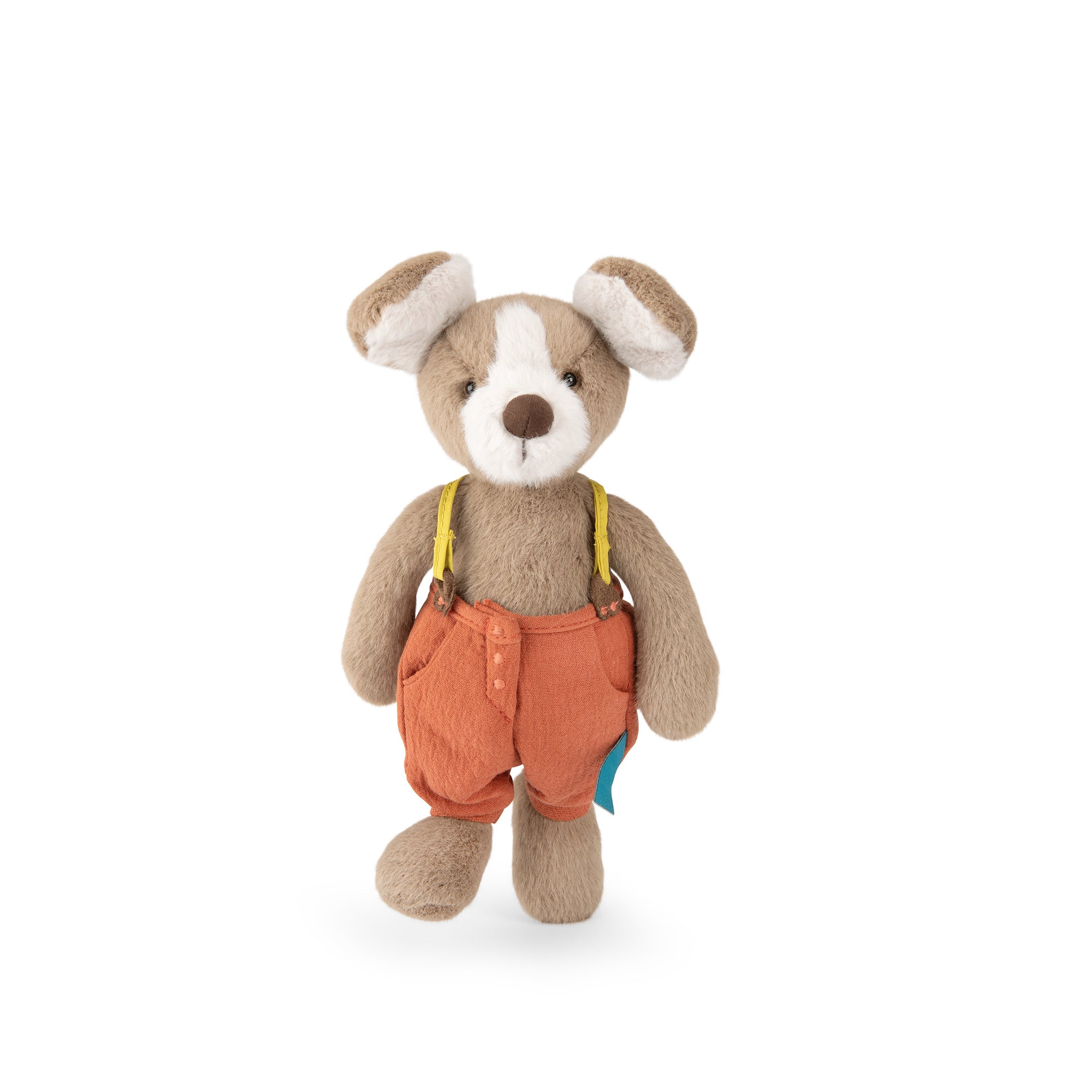 A plush stuffed animal shaped like a small brown dog wearing orange corduroy-style overalls with yellow suspenders, photographed against a plain white background.