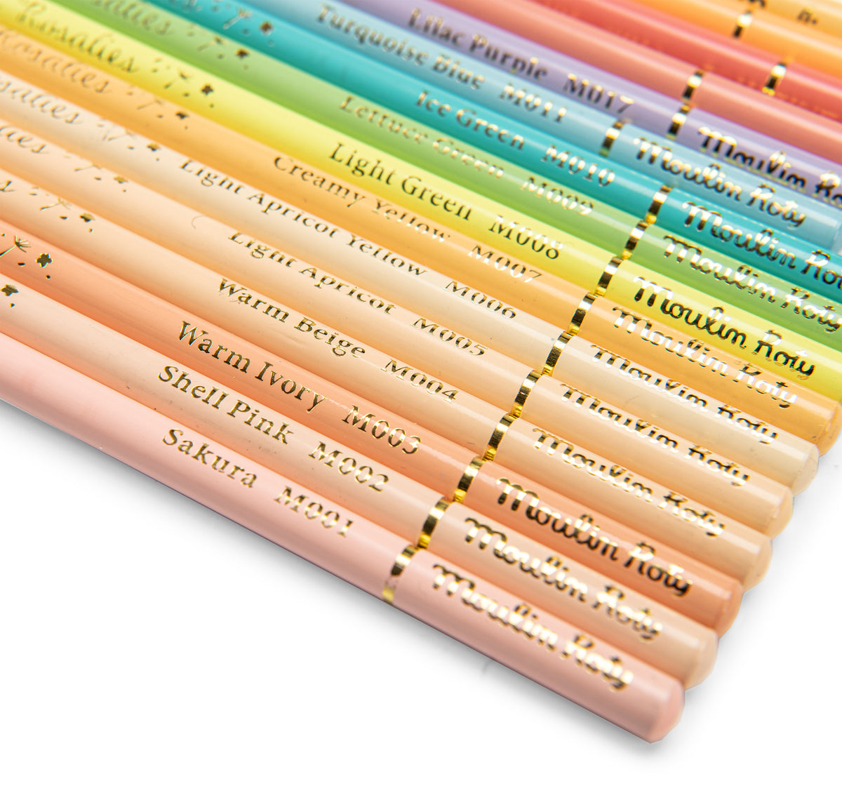 A close-up diagonal arrangement of pastel-colored wooden pencils with gold lettering on white barrels, showing shades from pale pink and peach through yellow, green, blue, and purple.