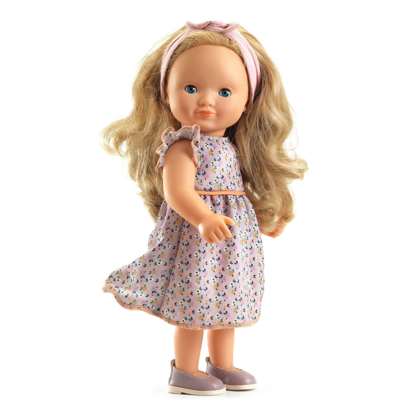 Doll with blonde hair and a floral dress on a white background