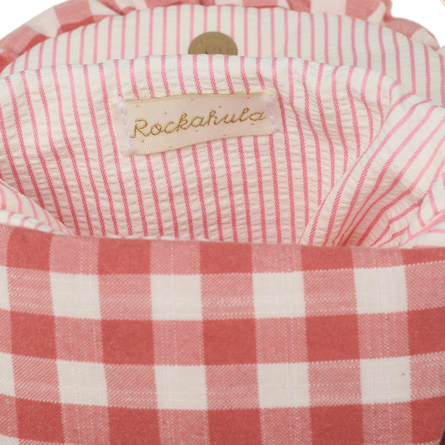 Close-up of a red and white checkered fabric with a 'Rockahula' label.